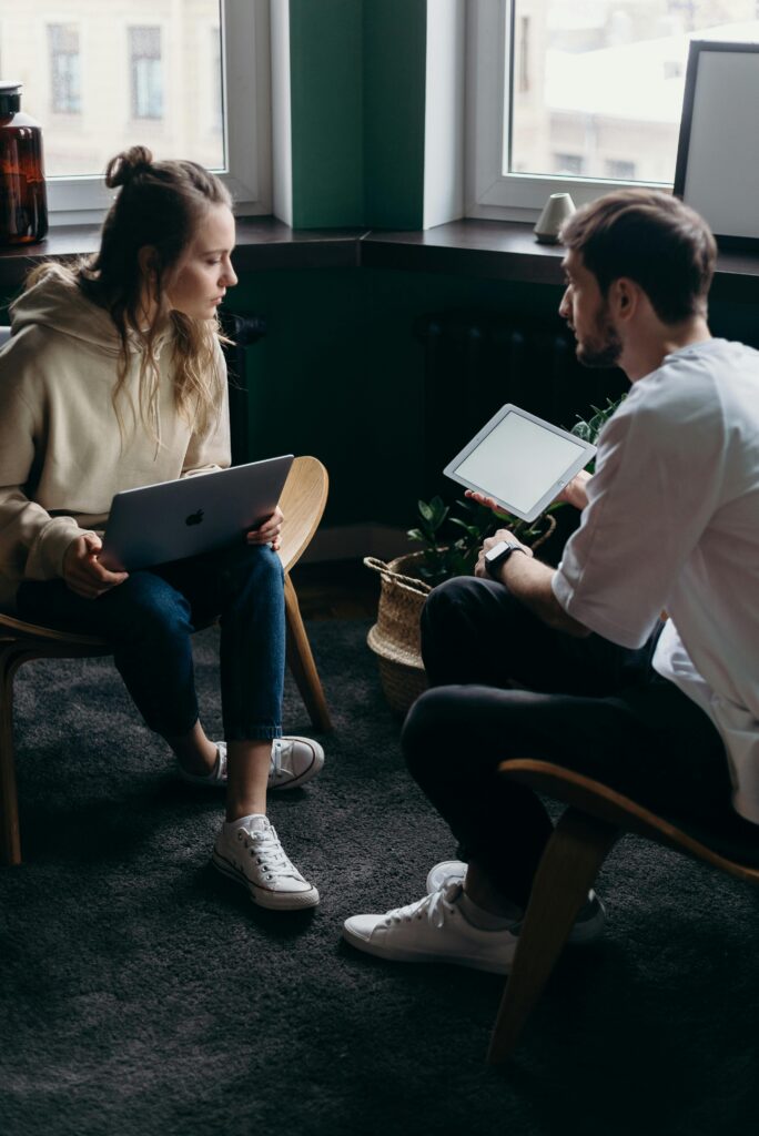 pexels-photo-4065158-4065158 Photo of Couple Talking While Holding Laptop and Ipad